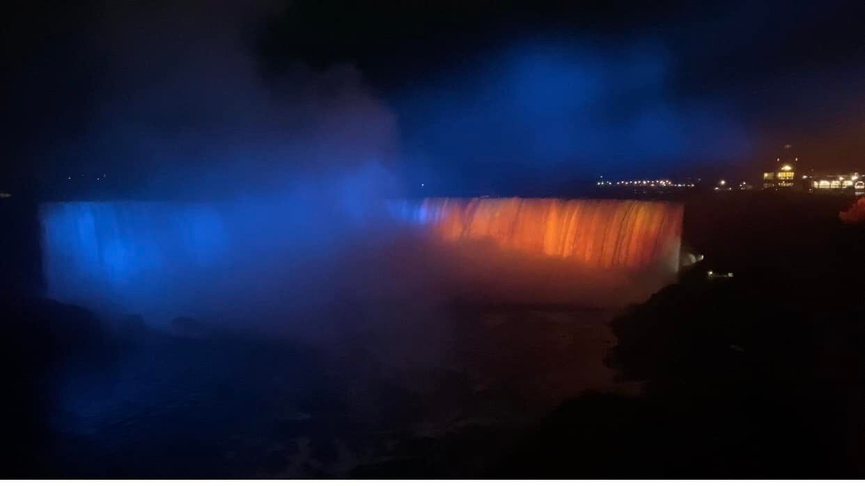 Niagara Falls illuminated in blue and yellow