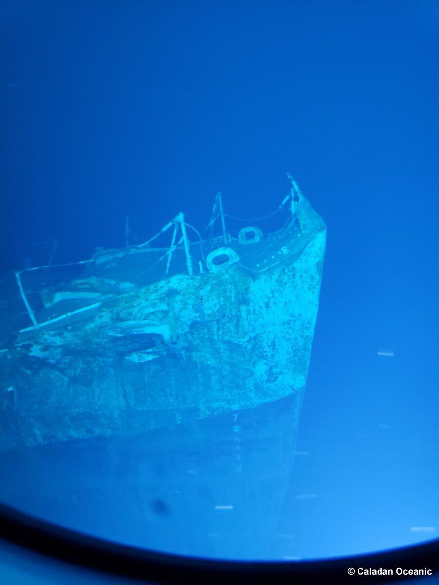 Scientists examine DE-413 with underwater cameras