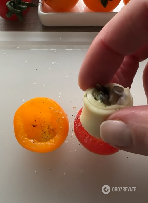 Putting mushroom rolls in empty tomatoes