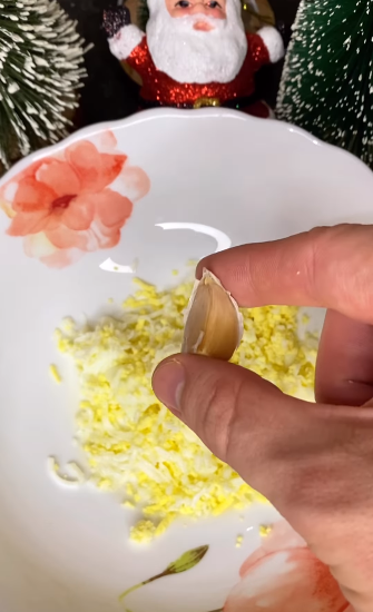 Grating the egg and adding garlic