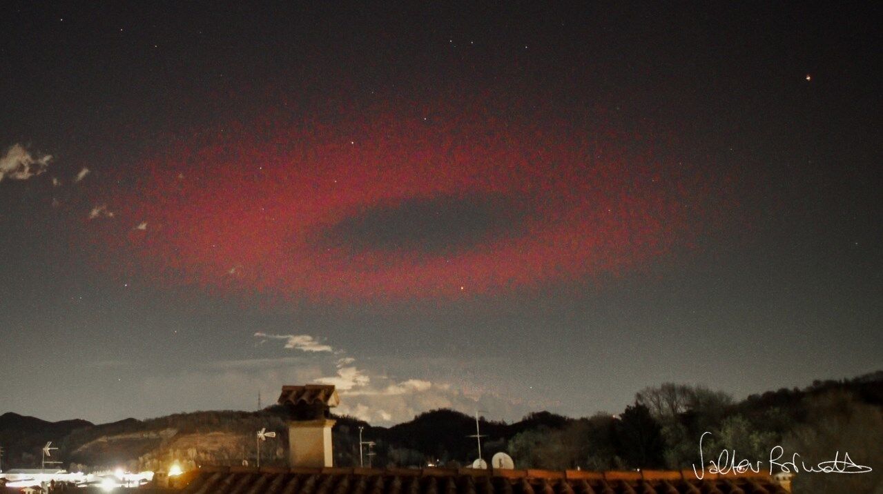A bizarre red UFO over the Italian city of Possagno turned out to be a natural phenomenon.