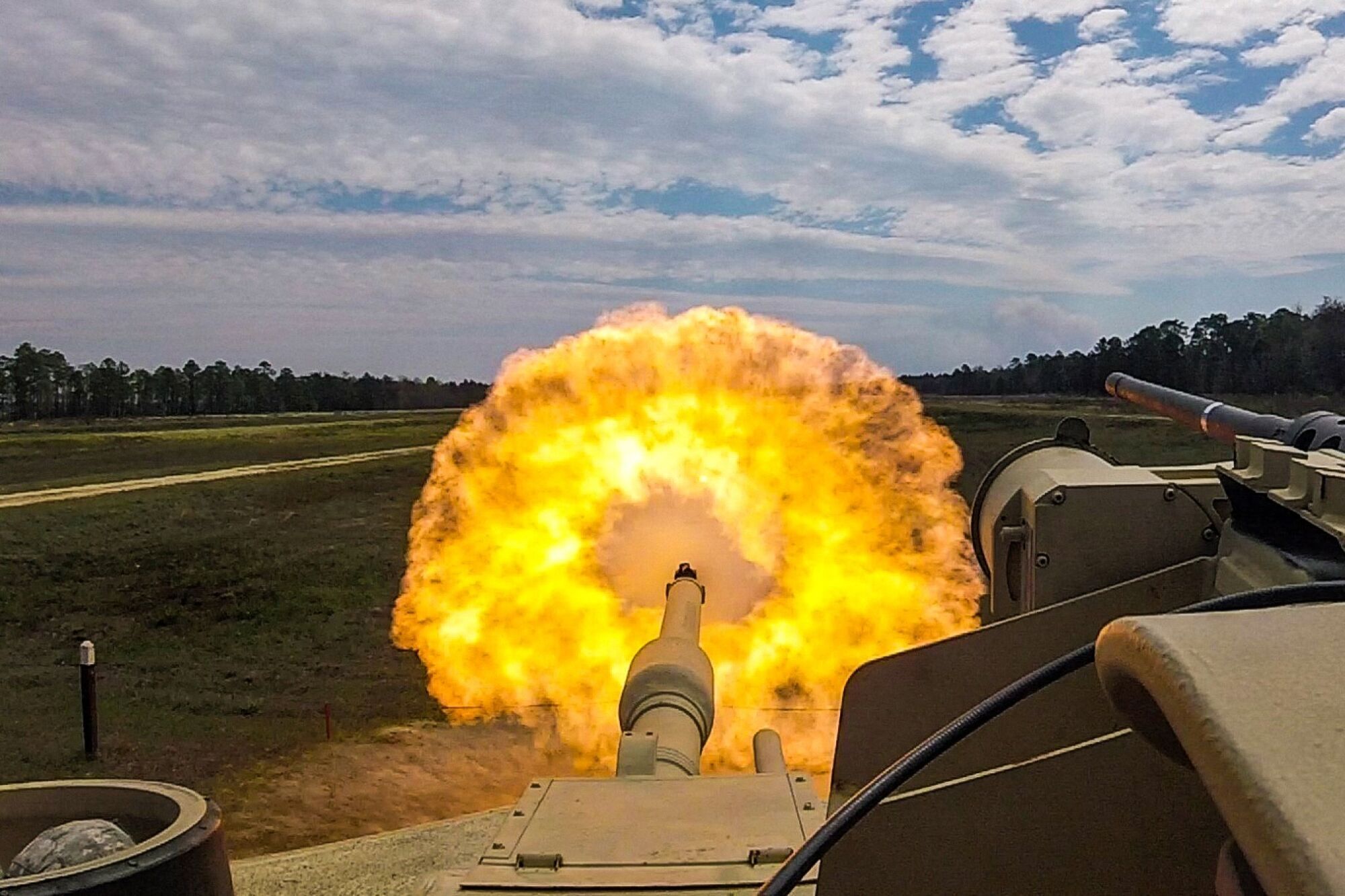 An M1 Abrams tank is firing.