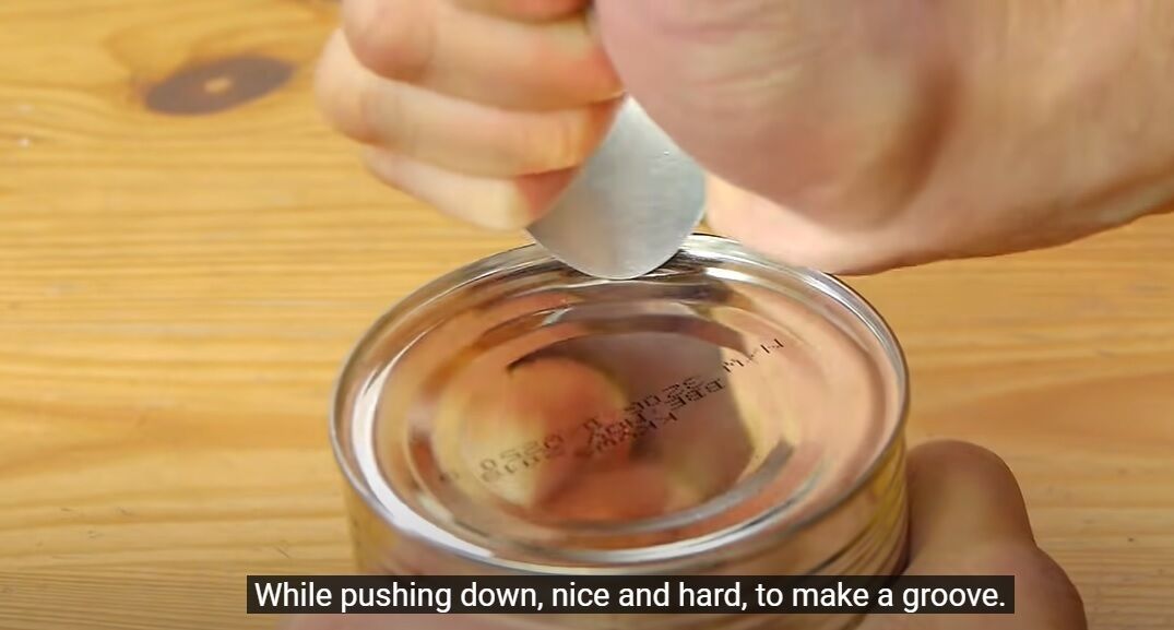 A clever lifehack to open a canning jar with a spoon