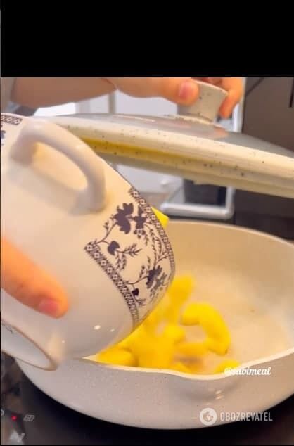 Putting chopped potatoes in a frying pan