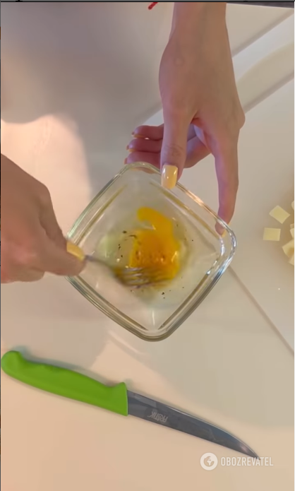 Whipping an egg with salt and pepper for a dish