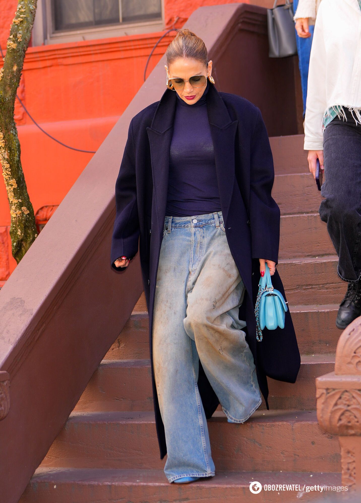 Jennifer Lopez joins the ''dirty denim'' trend of the 90s, showing off popular jeans