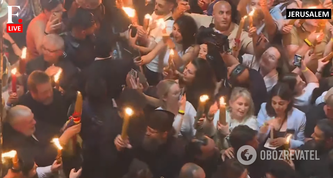Believers with candles in the Church of the Holy Sepulcher.
