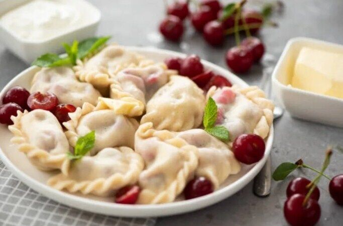 Lush dumplings with cherries on kefir