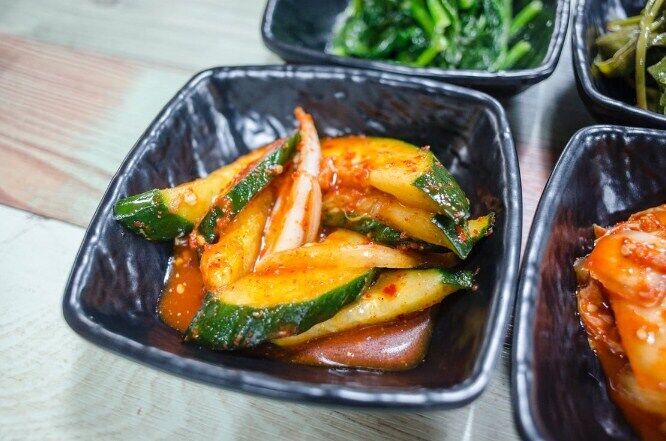 Winter salad with zucchini and peppers in tomato sauce