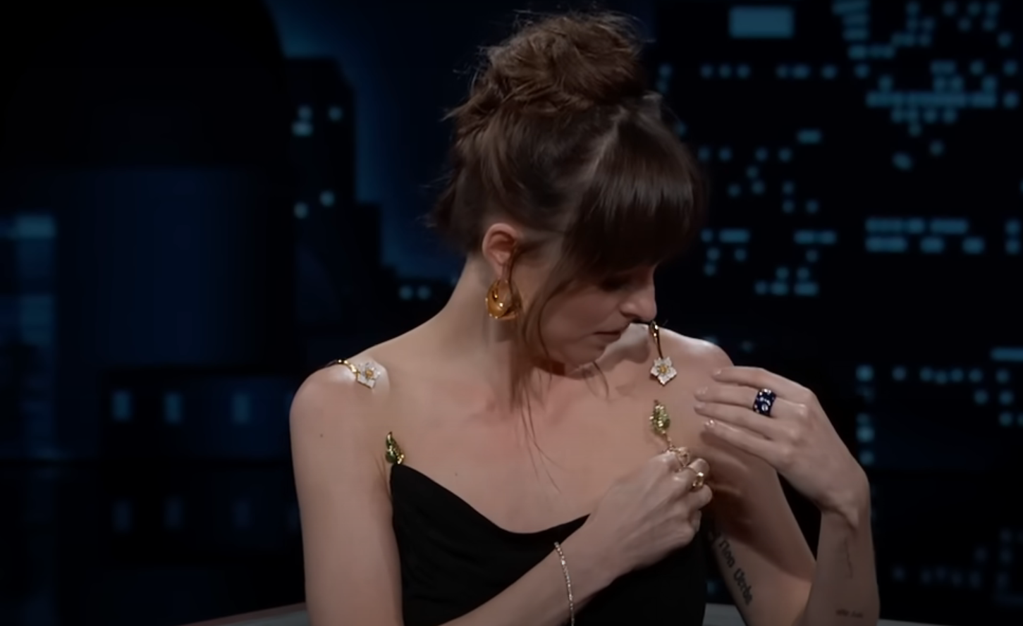 Dakota Johnson's dress almost fell down during an interview, but the Fifty Shades of Grey star quickly saved the situation. Video