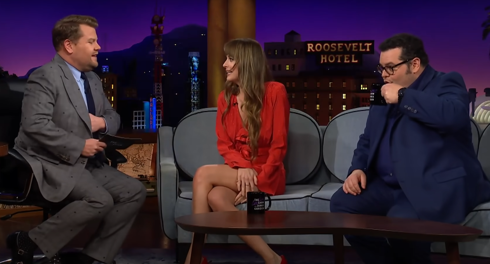 Dakota Johnson's dress almost fell down during an interview, but the Fifty Shades of Grey star quickly saved the situation. Video