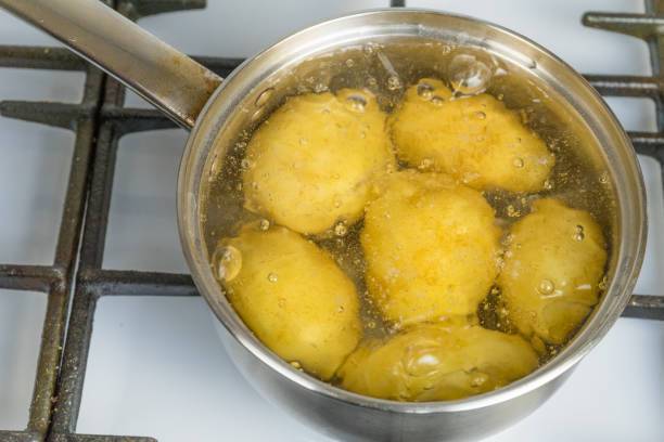 Why pour boiling water over potatoes before baking