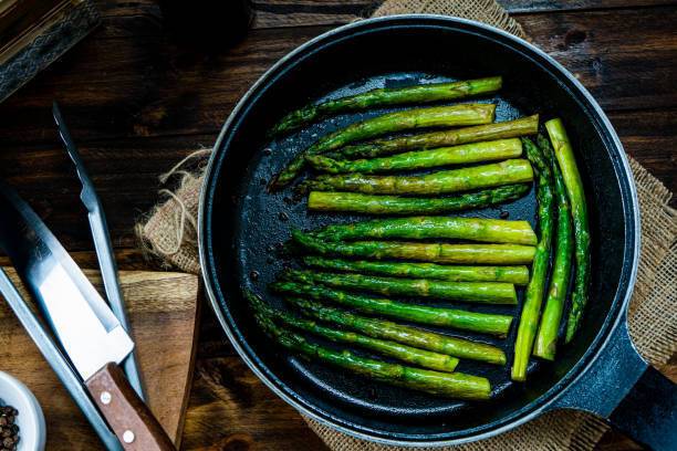 Fried asparagus in a pan