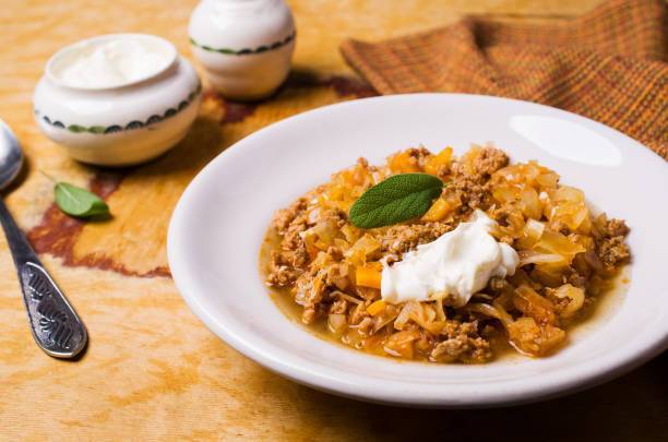 Stewed cabbage with meat and sour cream.