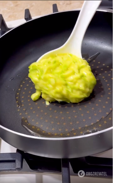 Frying zucchini pancakes.