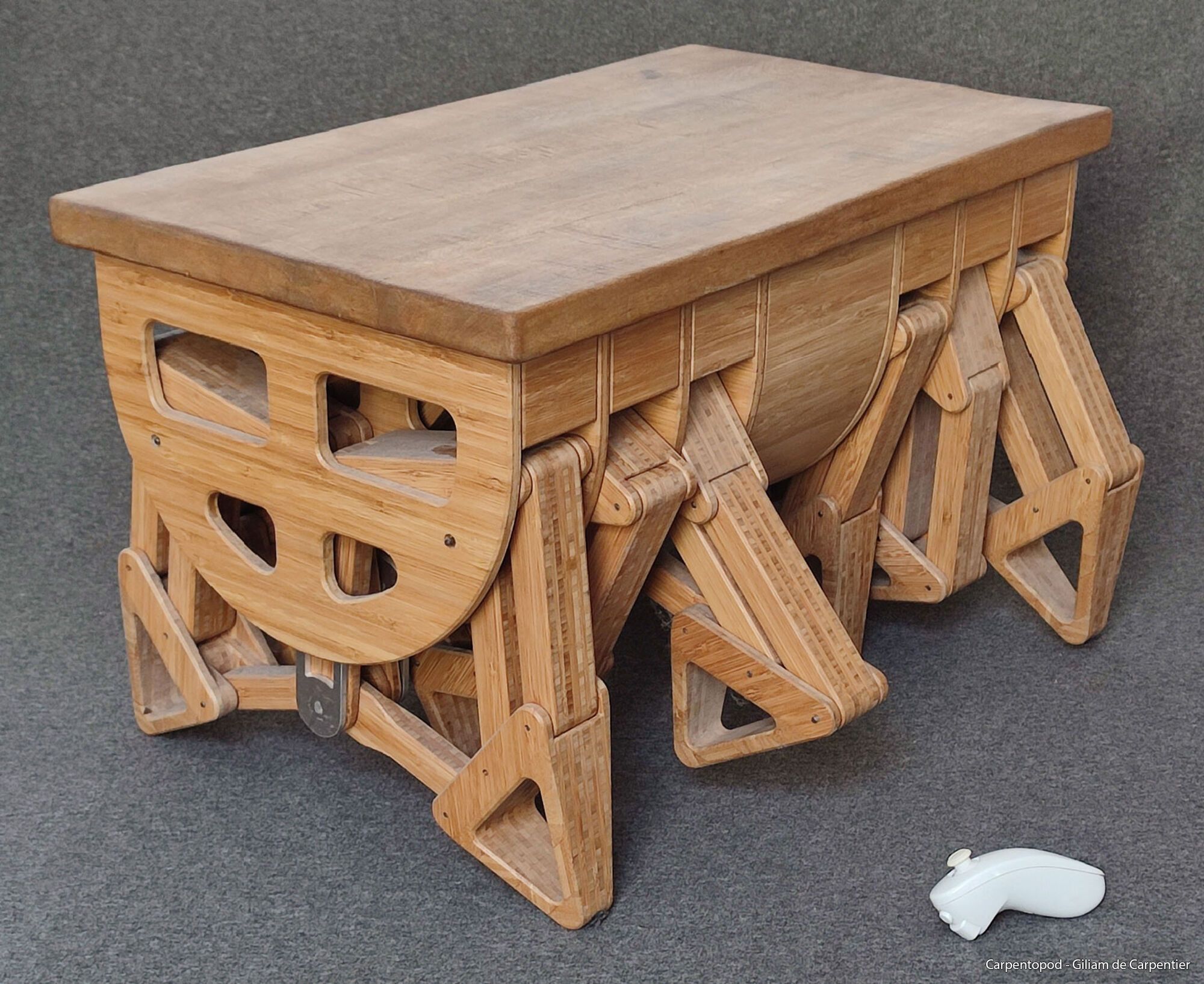 A carpenter from the Netherlands made a funny table with 12 legs that can move around the room to serve you food or drinks. Photos and video