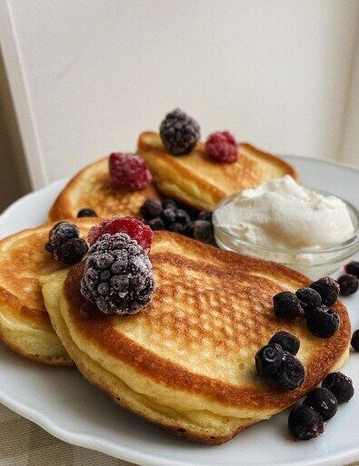 Pancakes with berries and sour cream.