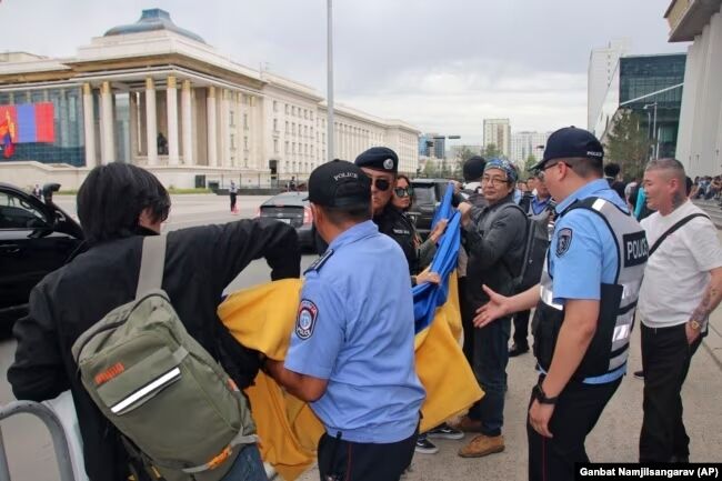 Protesters unfurl Ukrainian flag during Putin's visit to Mongolia. Photo