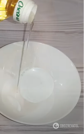 Pouring oil through a convenient opening into a container