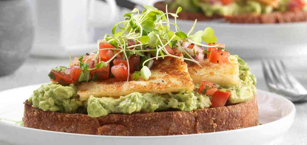 A light and tasty avocado toast with halloumi cheese and lime honey