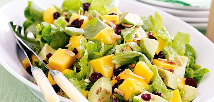 Light summer salad of greens, avocado and red fish: what to dress with