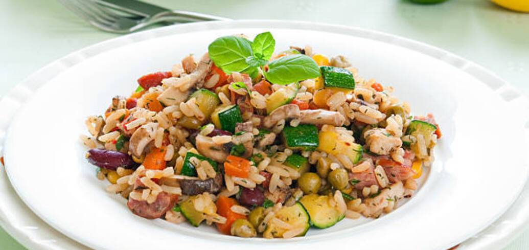 Rice with vegetables and meat: how to cook a delicious side dish in the oven