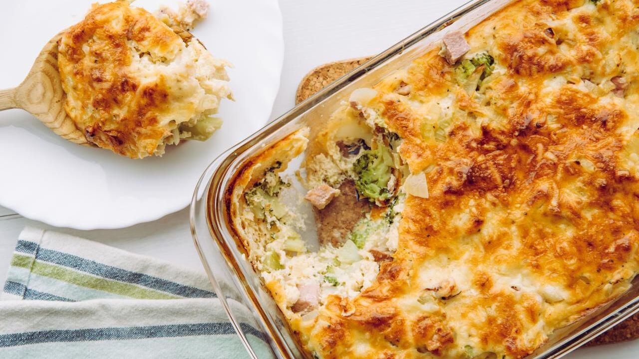 Healthy no-dough fish casserole with creamy sauce, onions and carrots