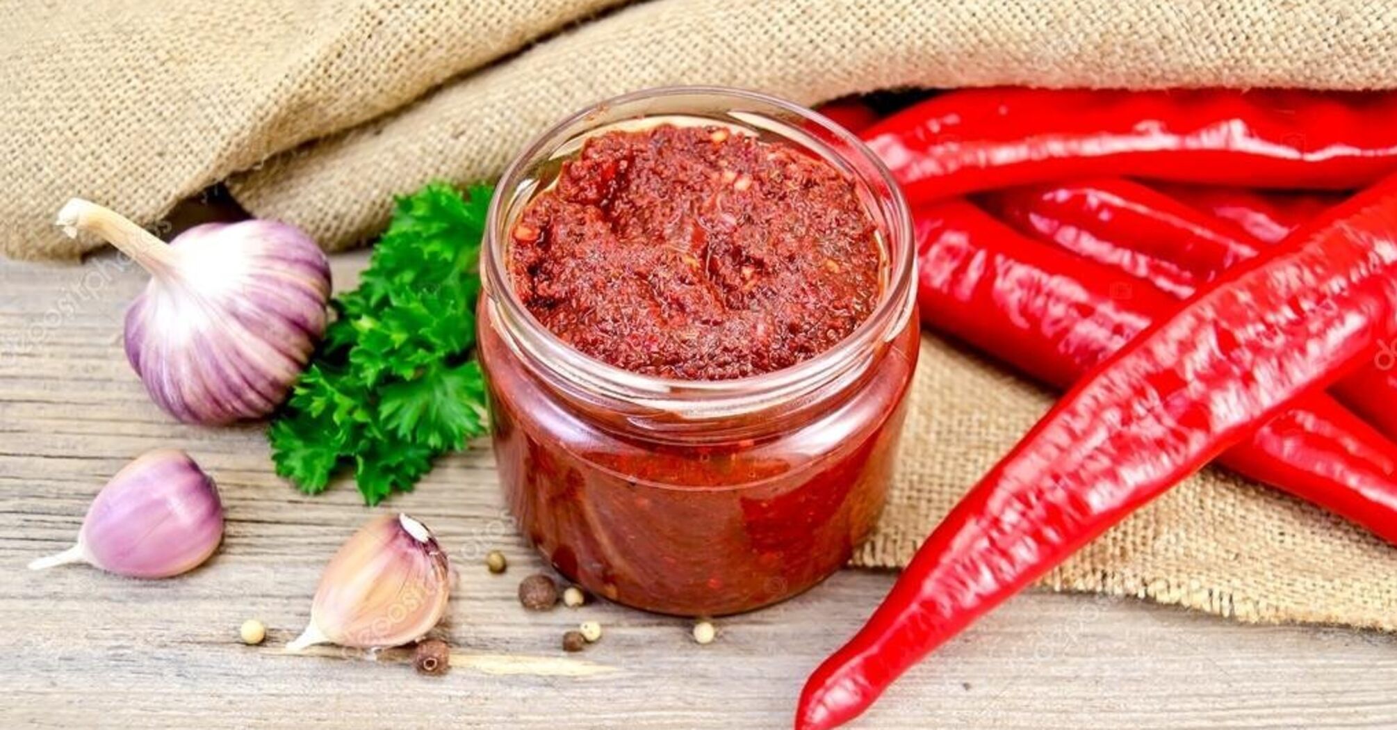 Tasty adjika with tomatoes and peppers for the winter: what to add for better flavor