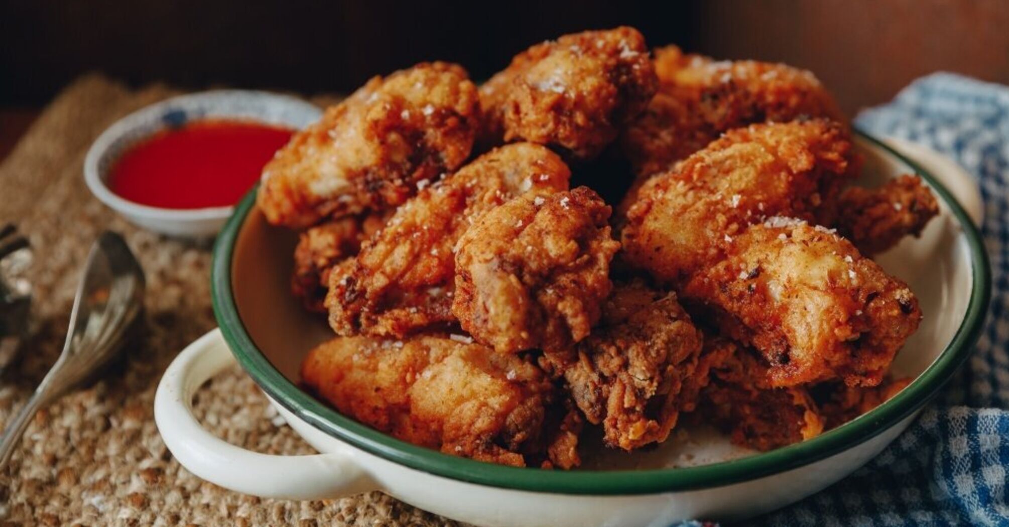 Crispy fried wings in a pan: delicious sauce