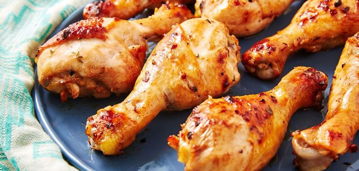 Baked chicken drumsticks with vegetables in foil for dinner: the meat will be very juicy